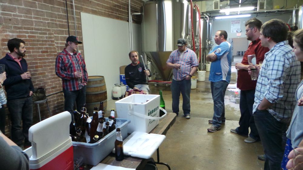 The group gets some pointers from award-winning brewer Michael Peticolas