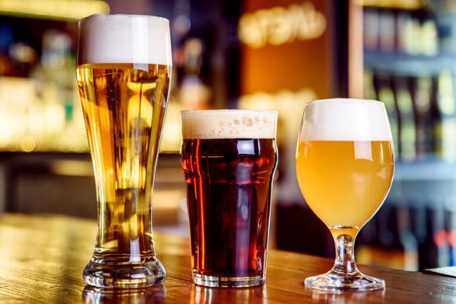 A variety of craft beers in different styles and colors on a bar counter
