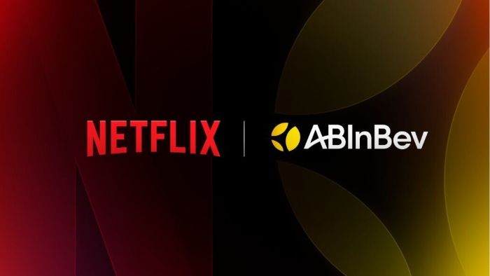The Netflix logo in red and the AB InBev logo in yellow and black are positioned side-by-side on a dark, gradient background, signifying their recently announced global brand partnership.