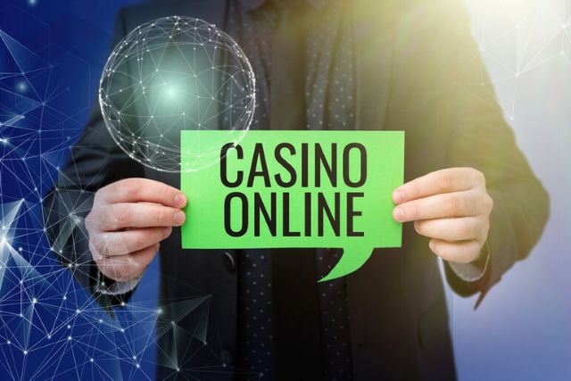 A gambler holding a green sign with 'Casino Online' text