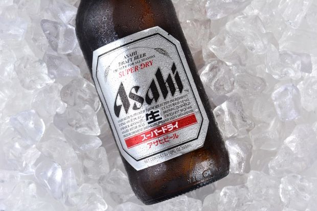 "Asahi Super Dry beer bottle chilled on ice, showcasing the iconic silver label and Japanese draft beer branding