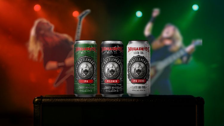 Three cans of Rattlehead beer on a black surface, with a blurred background of two people on a stage playing electric guitars under red and green lights. The three cans are for Rattlehead IPA, Rattlehead Pilsner, and Rattlehead IPA Zero. They are part of a line of beers from Megadeth Beer Co., founded by Dave Mustaine, and brewed in collaboration with Black Sheep Brewery.