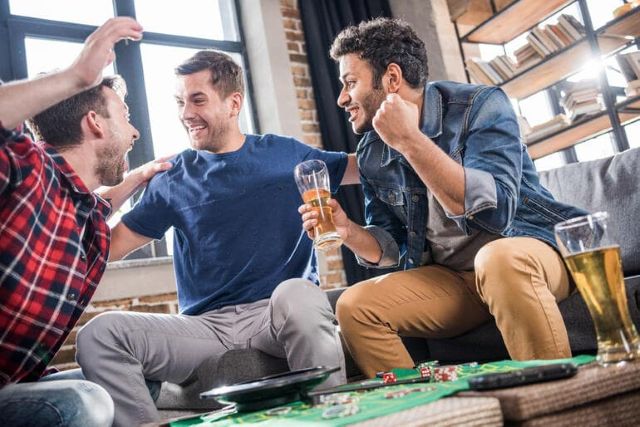 Playing cards spread on green felt next to beer, echoing the thrill of both beer lovers and gamblers in a casino