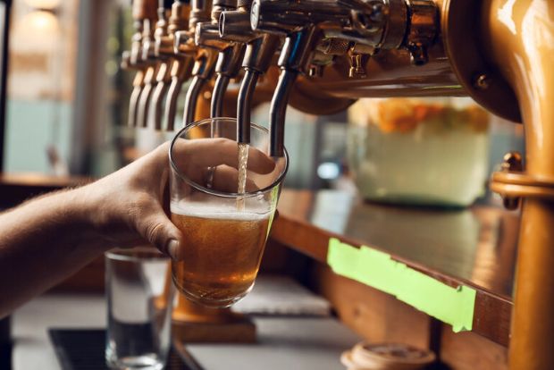 Bartender pouring craft beer from a tap at a Florida brewer