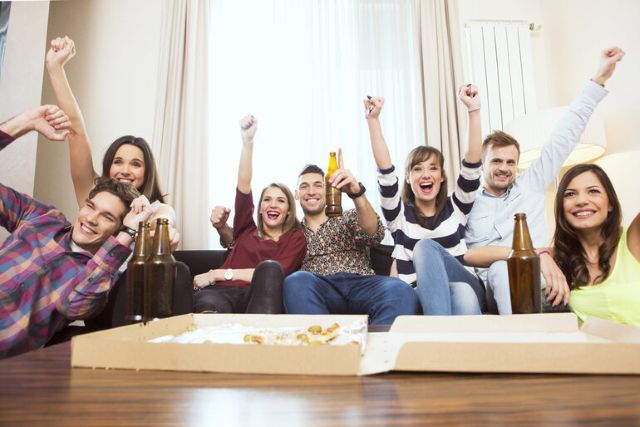 Young people enjoying a movie and beers