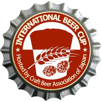 Bottle cap logo with the text "International Beer Cup" hosted by the "Craft Beer Association of Japan", featuring graphics of a beer glass, wheat stalk, and hops