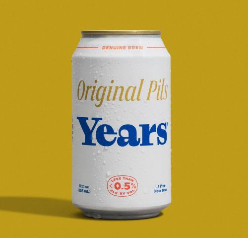 A white and gold can of Years Original Pils beer against a yellow background.