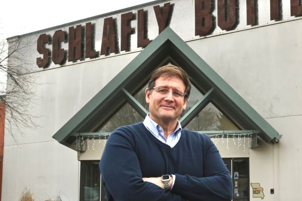 James Otoloini standing in front of Schlafly Beer building
