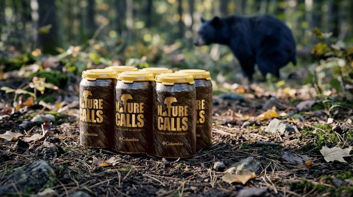 6-pack of "Nature Calls" beer sitting on the forest floor, with a black bear visible in the background.