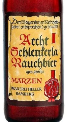 A close-up of a glass beer bottle with a parchment-style label featuring German text in a Gothic font, including the words "Aecht Schlenkerla Rauchbier" and "MARZEN", and a red wax seal logo