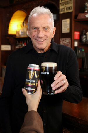 NFL legend Joe Montana stands in a pub and hands off a can and glass of the new, limited-edition Guinness Legends Lager beer.