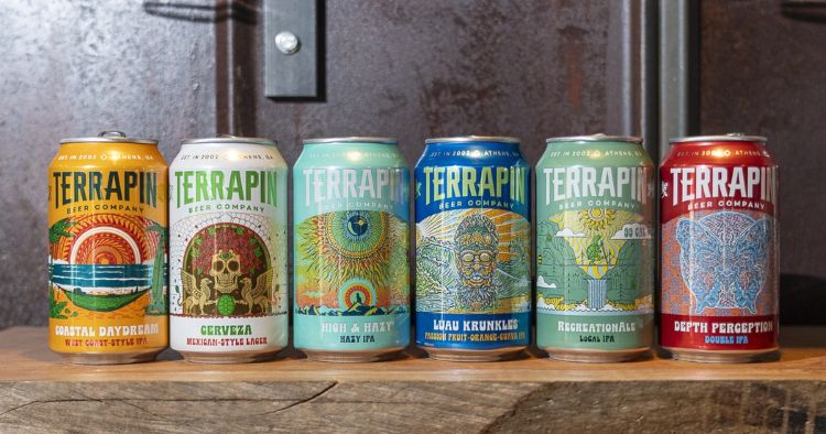 A row of six colorful Terrapin Beer Company cans with different labels including "Coastal Daydream," "Cerveza," "High & Hazy," "Luau Krunkle," "Recreational," and "Depth Perception.