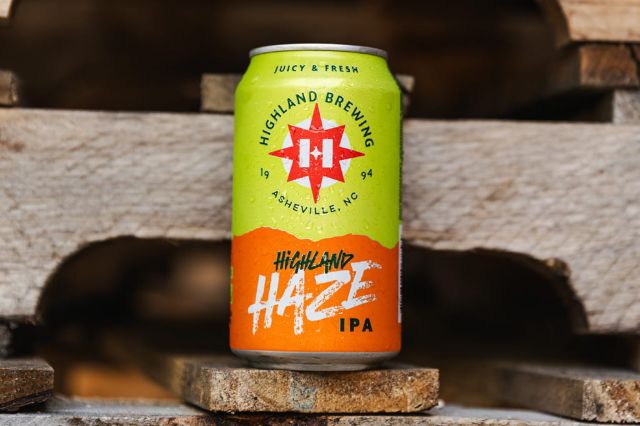 A can of Highland Haze IPA by Highland Brewing sits on a rustic wooden pallet.