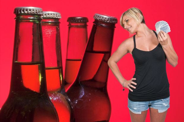 Craft beer bottles and a woman with gambling cards.