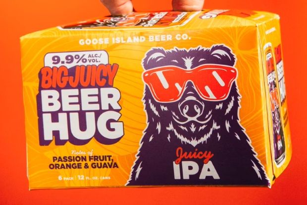 A 6-pack box of Goose Island "Big Juicy Beer Hug" Juicy IPA features a bear wearing red sunglasses.