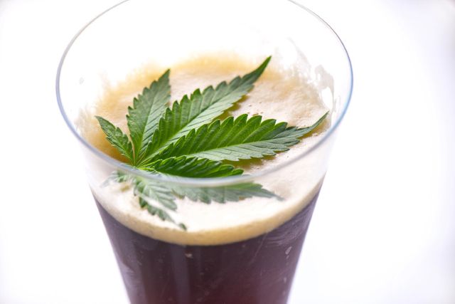 A flask containing cannabis displayed on a wooden shelf, symbolising alternative consumption choices in the “Cali Sober” lifestyle trend.