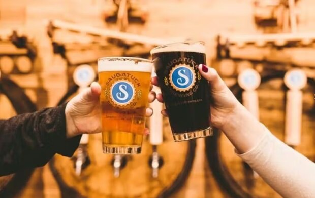A toast with two beers at Saugatuck Brewing Company.