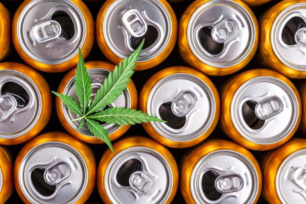 Beverage cans with a cannabis leaf, representing the rise of THC drinks among craft beer enthusiasts.