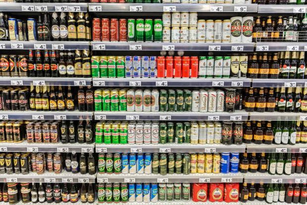Beer cans and bottles displayed on retail shelves, showcasing a variety of colorful beer label designs that inspire branding ideas for new breweries.