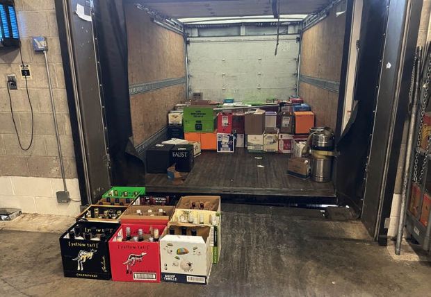 Craft beer cases loaded into a delivery truck for interstate shipping, illustrating the challenges of shipping beer across state lines.