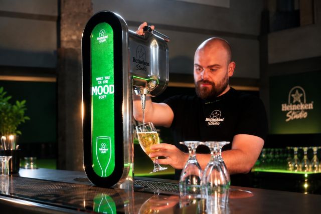 Heineken Studio bartender pours a beer from the company’s new AI-powered Personalized Draught tap.