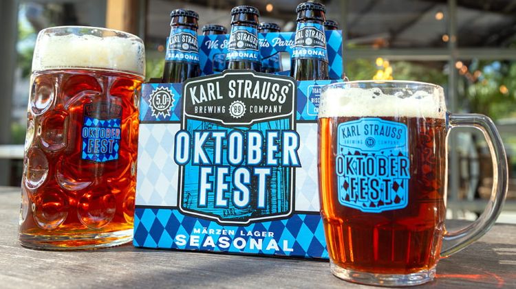 Karl Strauss Oktoberfest Märzen bottles and six-pack flanked by two steins filled with amber beer.